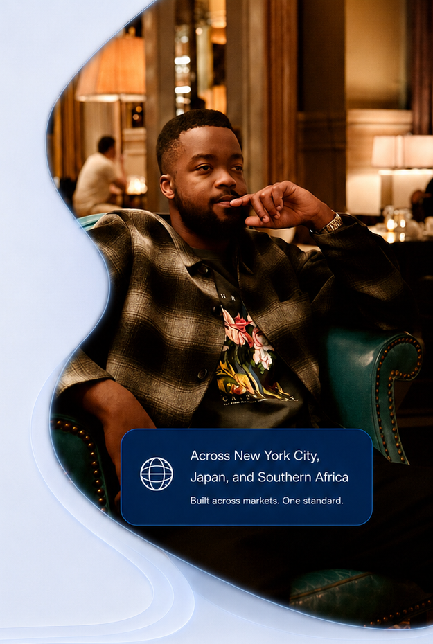 Ibrahim Phiri seated in a teal armchair in New York City